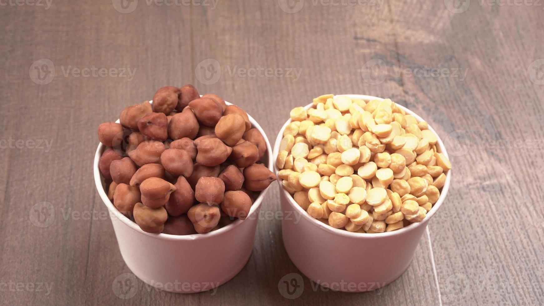 Black Chickpeas or Kala Chana with chana dal pulse isolated on wooden Background. photo