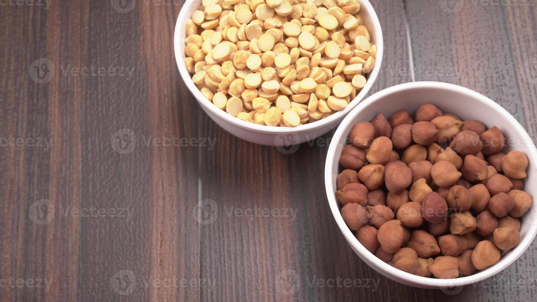 Black Chickpeas or Kala Chana with chana dal pulse isolated on wooden Background. photo