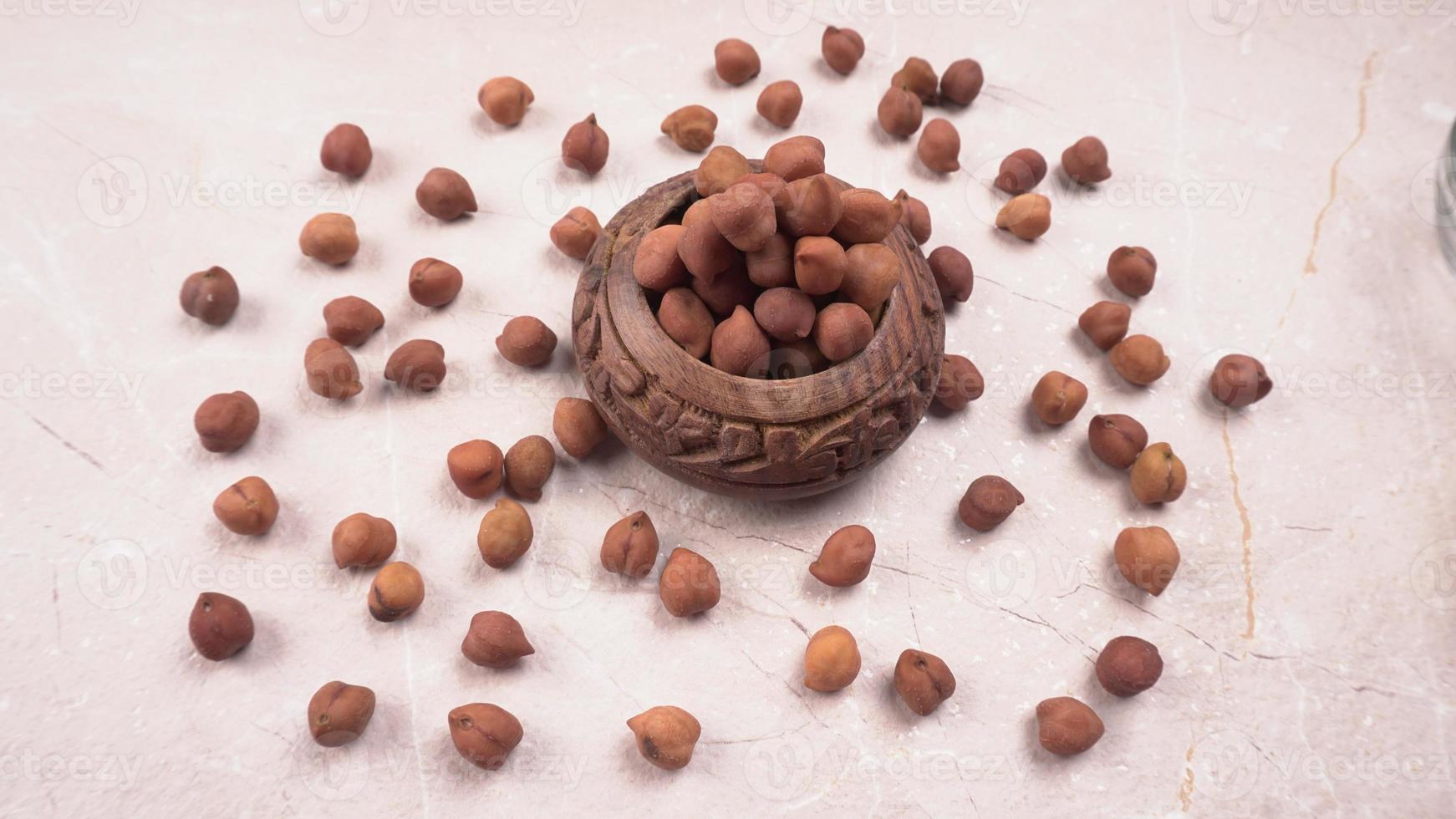 Black Chickpeas or Kala Chana with chana dal pulse isolated on wooden Background. photo
