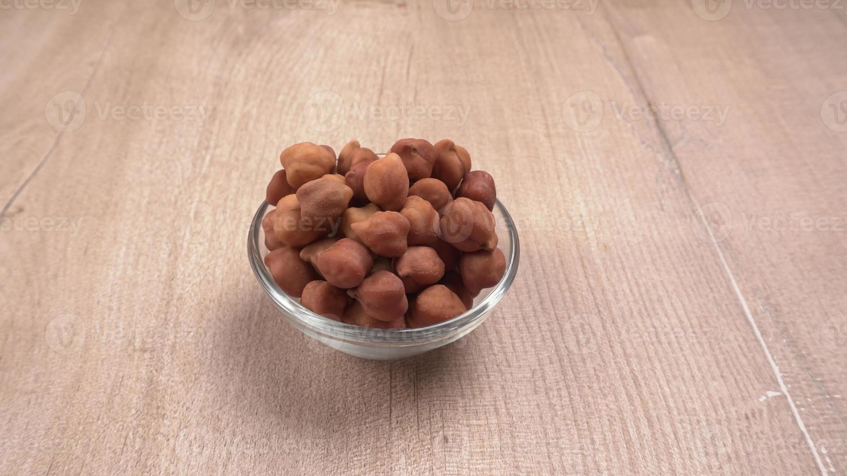 Black Chickpeas or Kala Chana with chana dal pulse isolated on wooden Background. photo