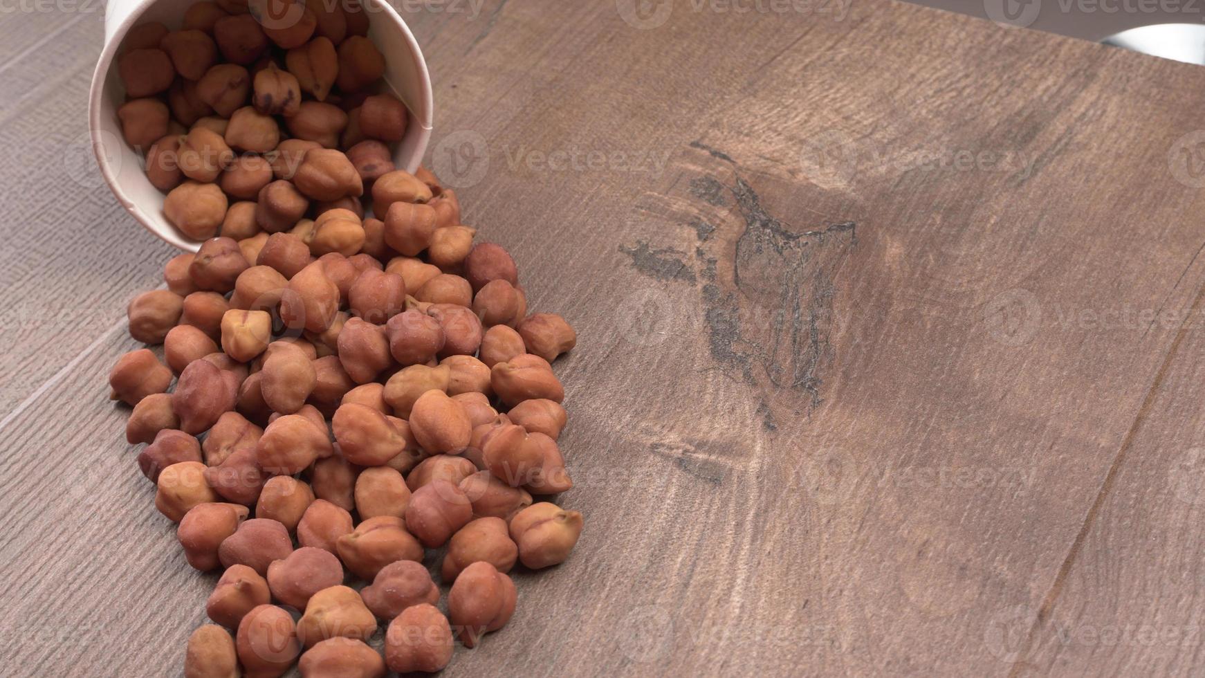 Black Chickpeas or Kala Chana with chana dal pulse isolated on wooden Background. photo