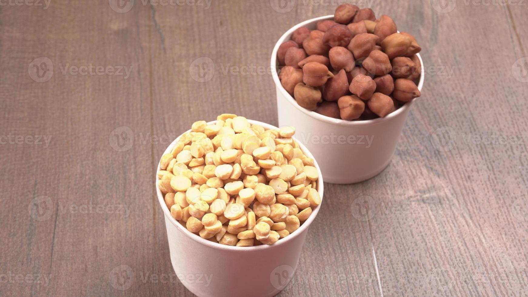 Black Chickpeas or Kala Chana with chana dal pulse isolated on wooden Background. photo