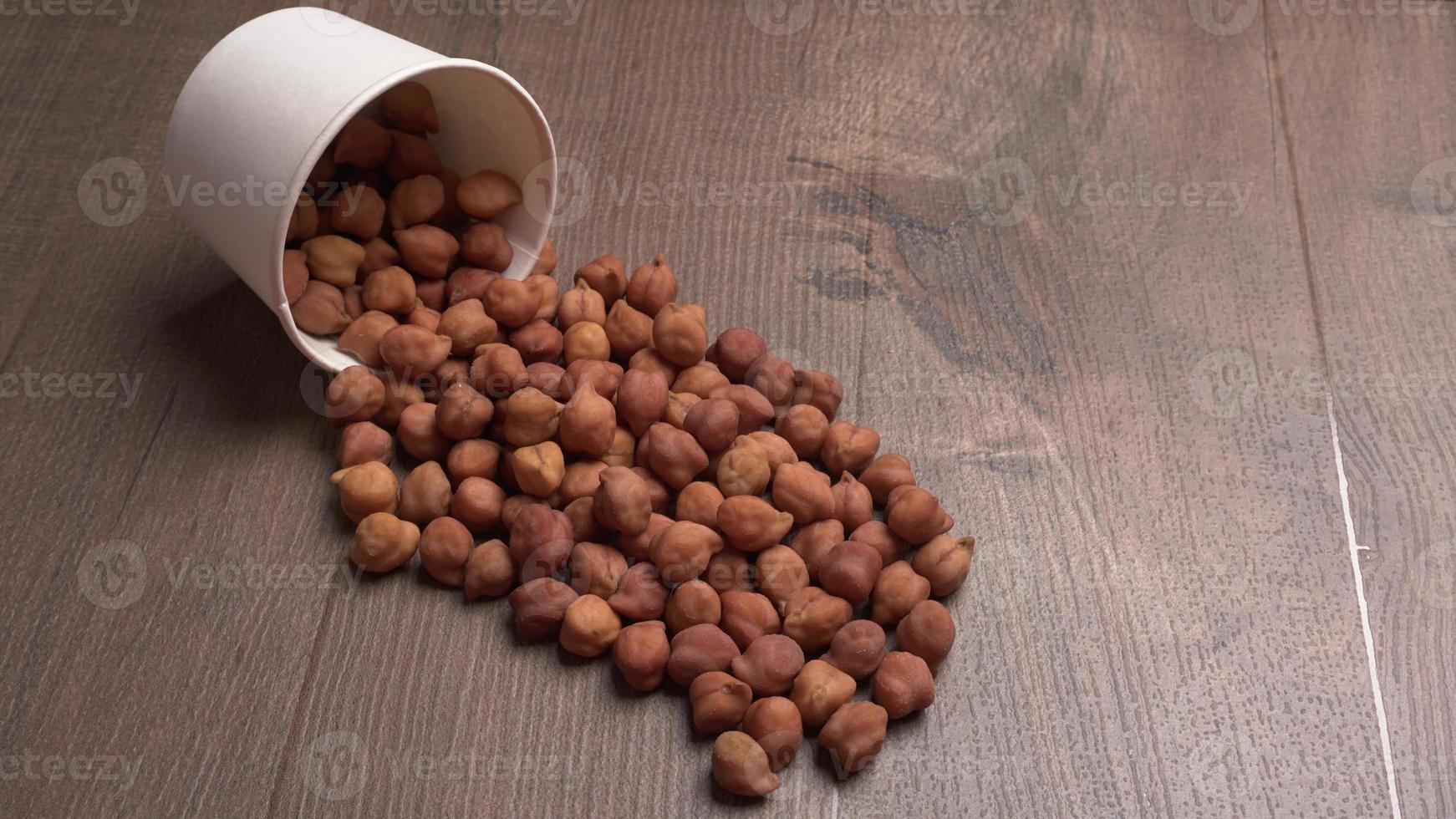 Black Chickpeas or Kala Chana with chana dal pulse isolated on wooden Background. photo