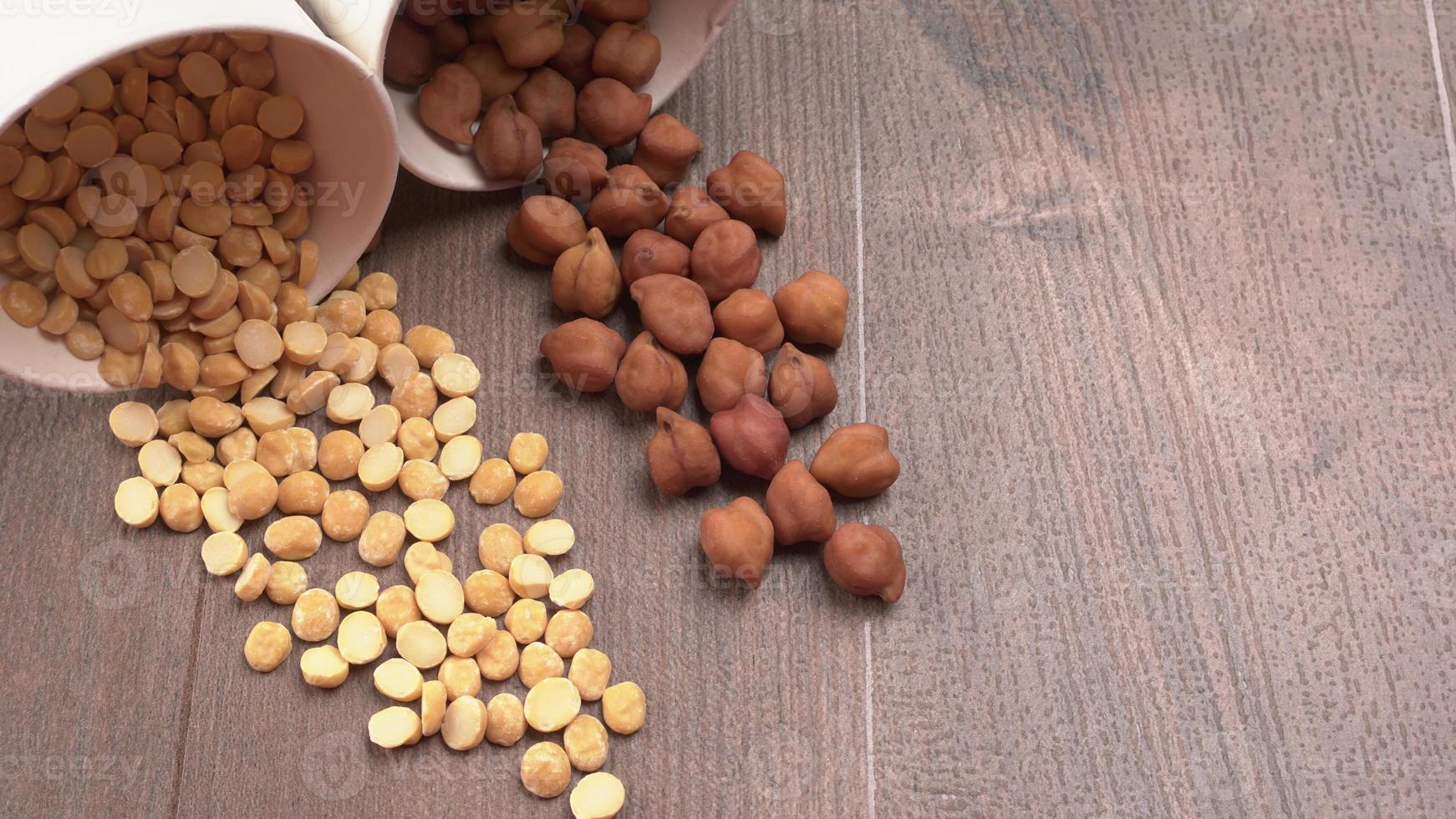 Black Chickpeas or Kala Chana with chana dal pulse isolated on wooden Background. photo