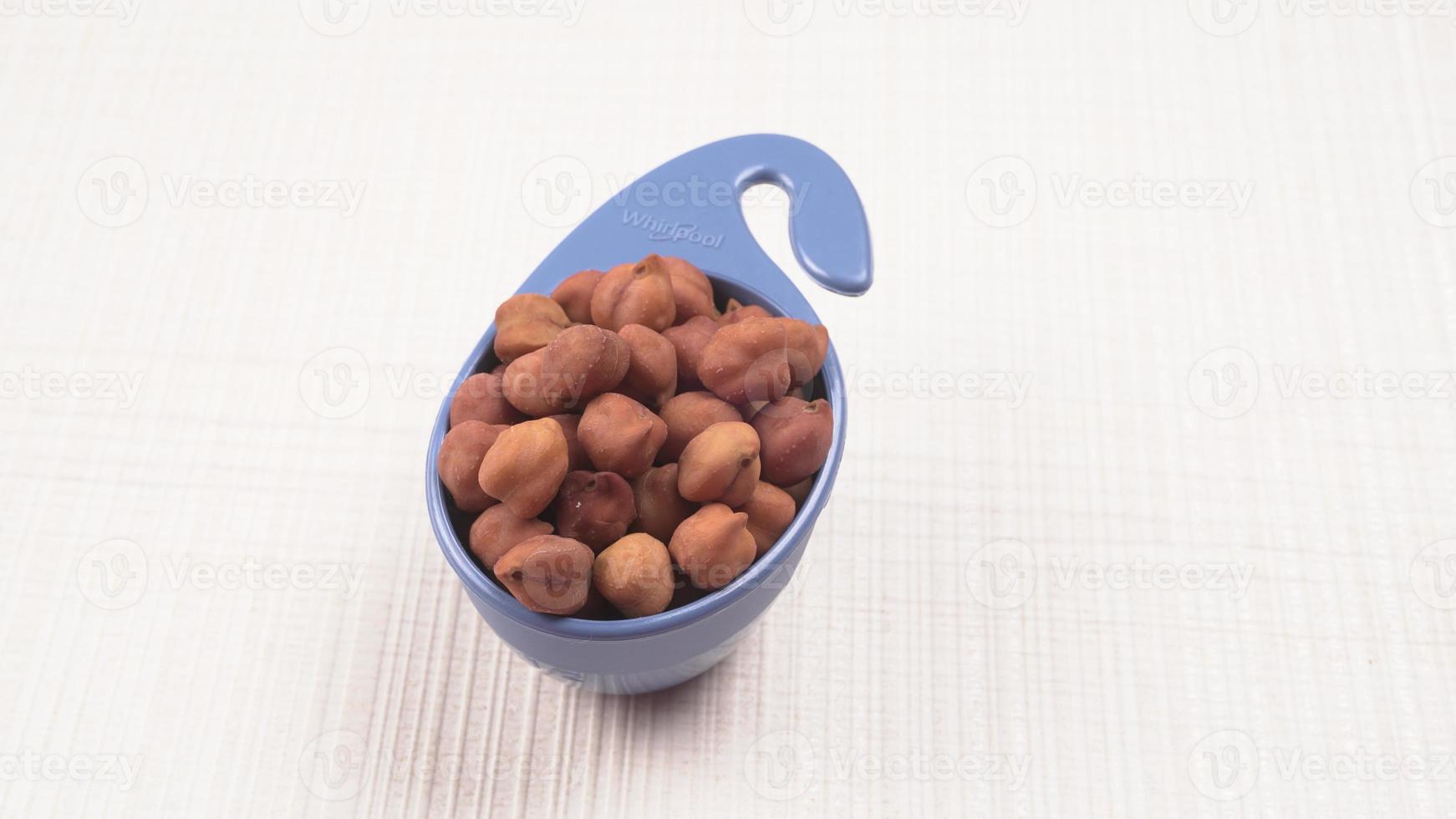 Black Chickpeas or Kala Chana with chana dal pulse isolated on wooden Background. photo