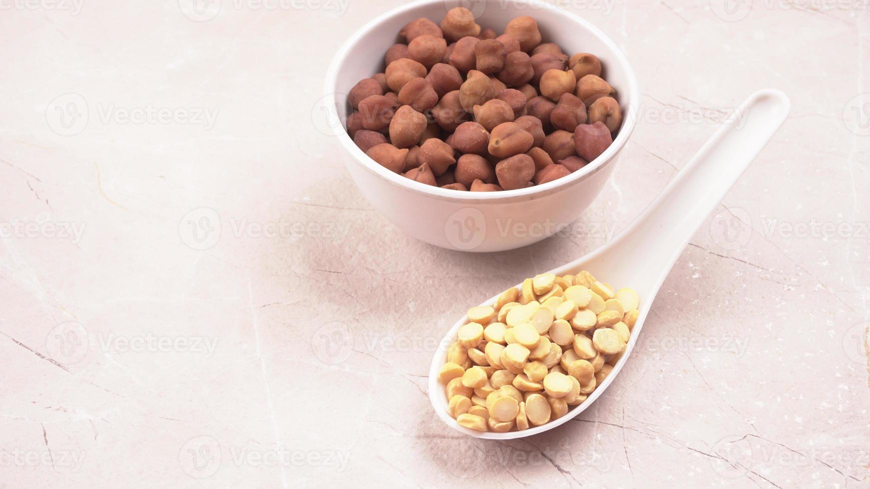 Black Chickpeas or Kala Chana with chana dal pulse isolated on wooden Background. photo