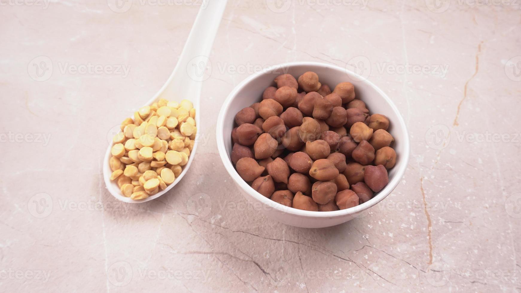 Black Chickpeas or Kala Chana with chana dal pulse isolated on wooden Background. photo