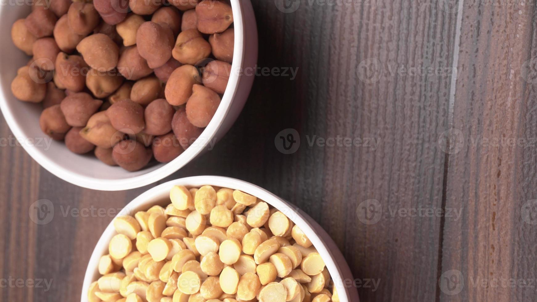 Black Chickpeas or Kala Chana with chana dal pulse isolated on wooden Background. photo
