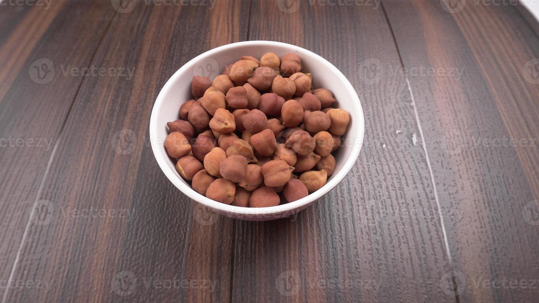 Black Chickpeas or Kala Chana with chana dal pulse isolated on wooden Background. photo