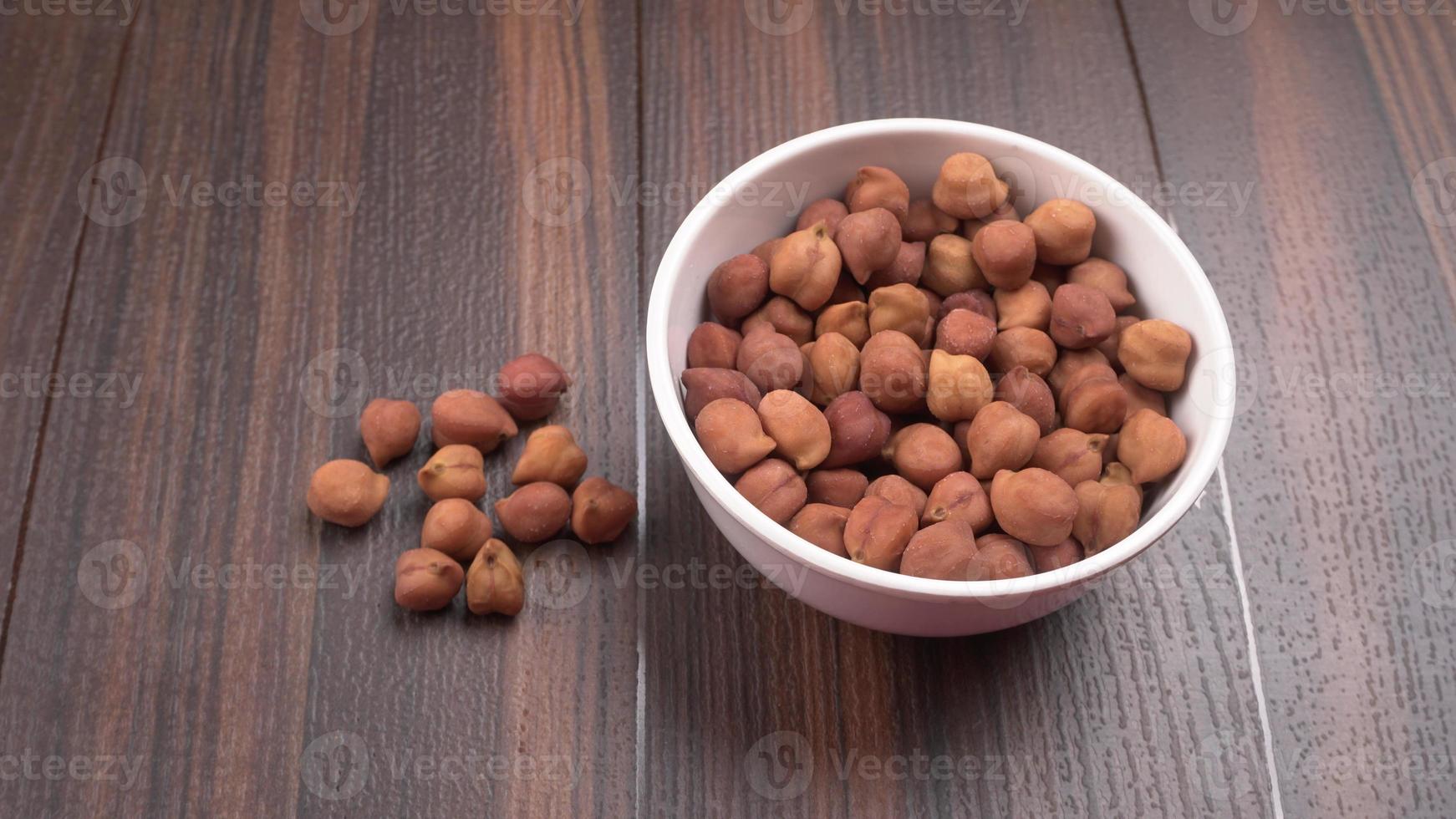 Black Chickpeas or Kala Chana with chana dal pulse isolated on wooden Background. photo