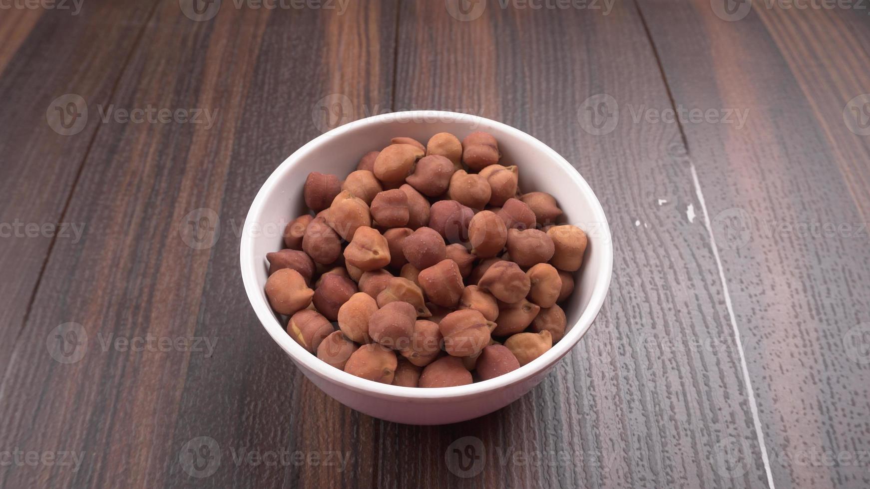 Black Chickpeas or Kala Chana with chana dal pulse isolated on wooden Background. photo