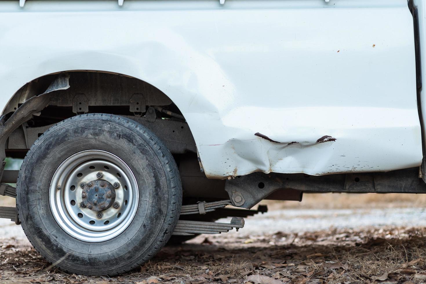 Closeup of a smashed of white car in an accident. photo