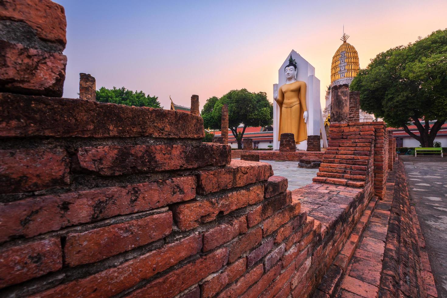 Buddha statue at sunset are Buddhist temple at Wat Phra Si Rattana Mahathat also colloquially referred to as Wat Yai is a Buddhist temple It is a major tourist attractions in Phitsanulok,Thailand. photo