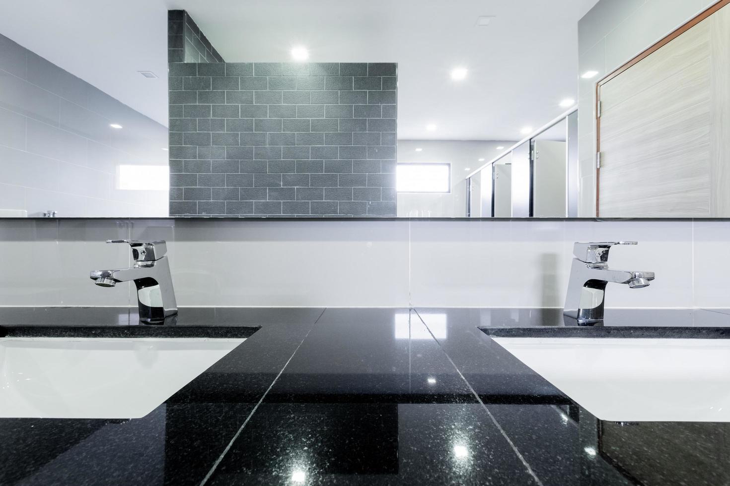 public Interior of bathroom with sink basin faucet lined up Modern design. photo