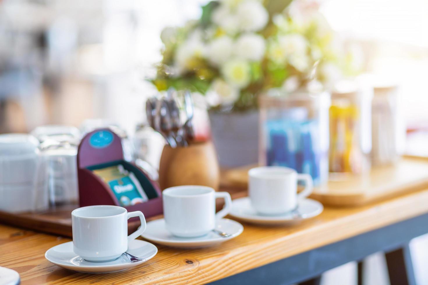 multiple rows of empty coffee cup on the dining table decoration at buffet self service at hotel. photo