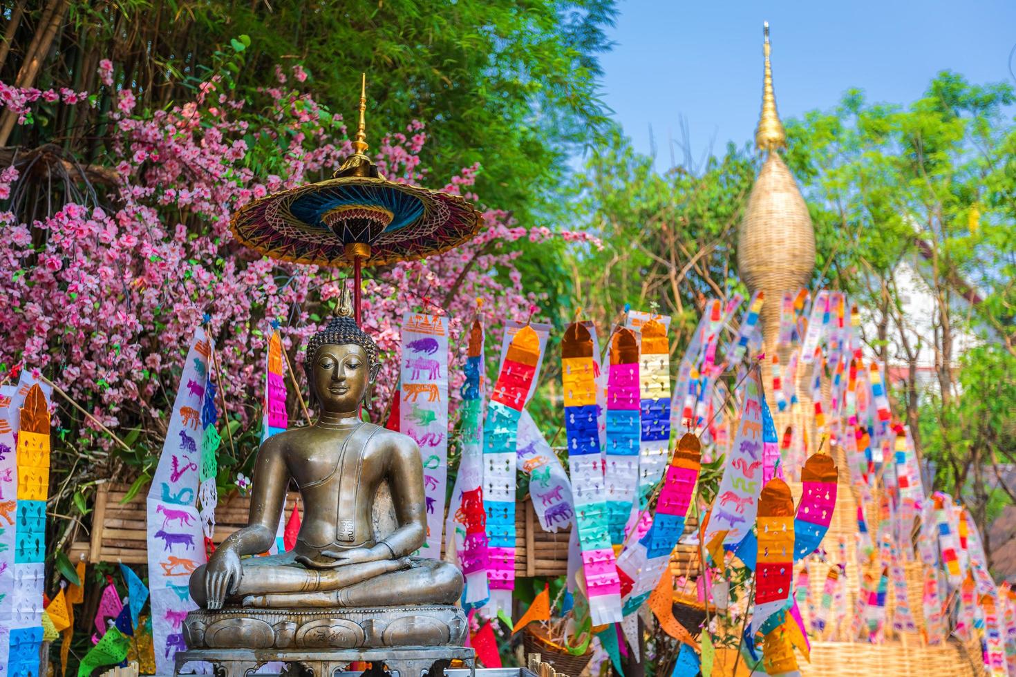 Prayer flags tung Hang with umbrella or Northern traditional flag hang on sand pagoda in the Phan Tao temple for Songkran Festival is celebrated in a traditional New Year's Day in Chiang Mai,Thailand photo