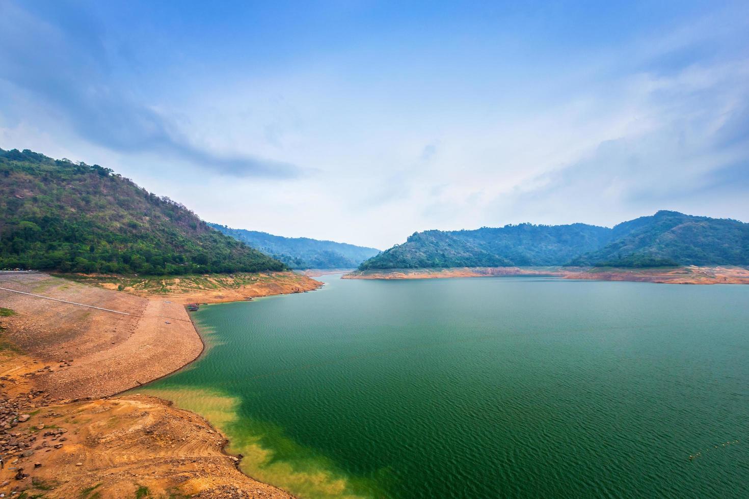 view of the river and mountains on Khun Dan Prakan Chon dam is largest and longest roller compacted concrete dam in the world during sunset in Nakonnarok Thailand. photo