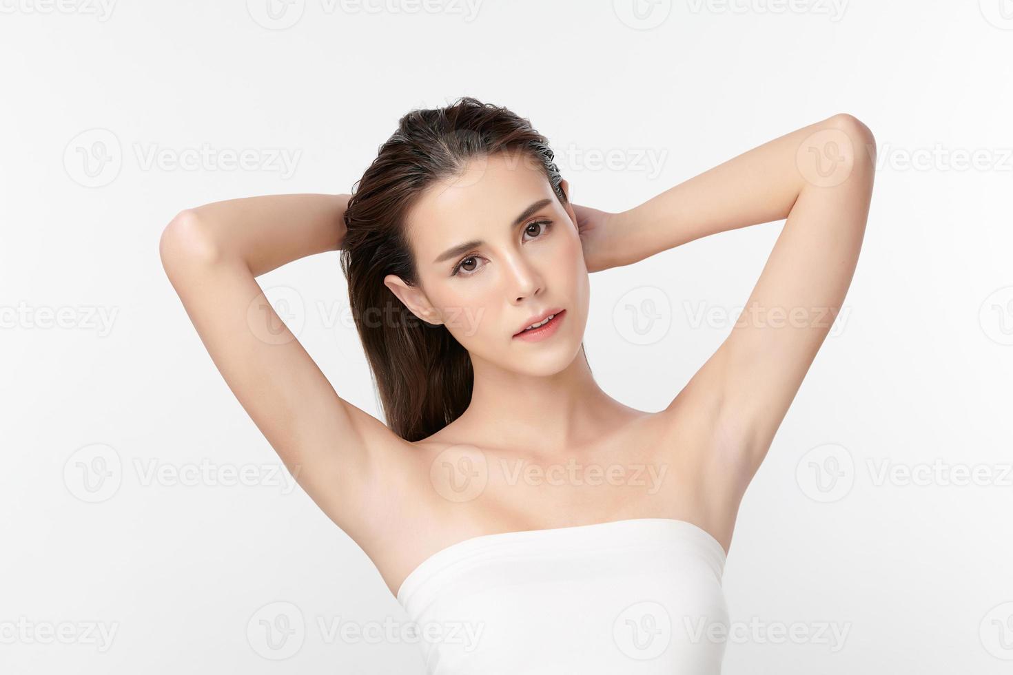 Beautiful Young Asian woman lifting hands up to show off clean and hygienic armpits or underarms on white background, Smooth armpit cleanliness and protection concept photo