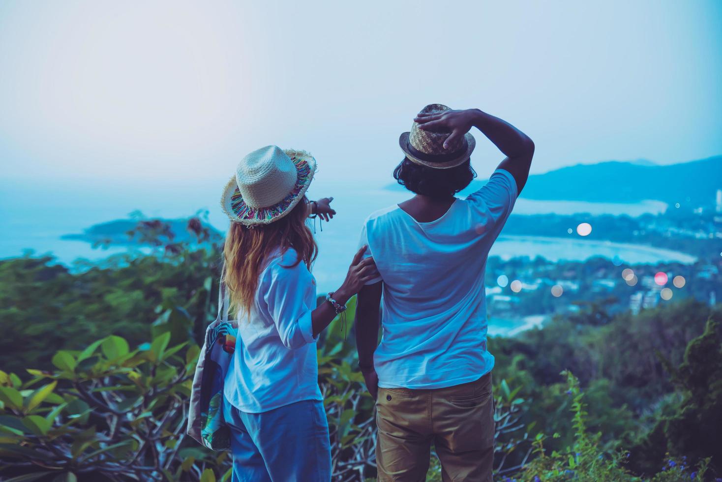 Middle aged Happy Romantic couple travel relax the beach in the holiday and standing watching the sunset. in summer photo