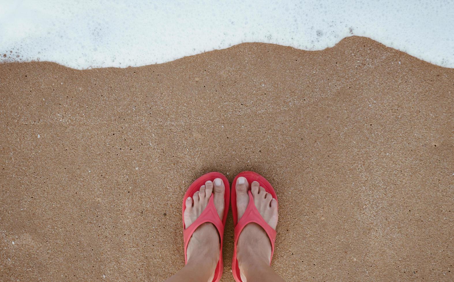 Summer vacation concept barefoot on sand at beach with copyspace. photo