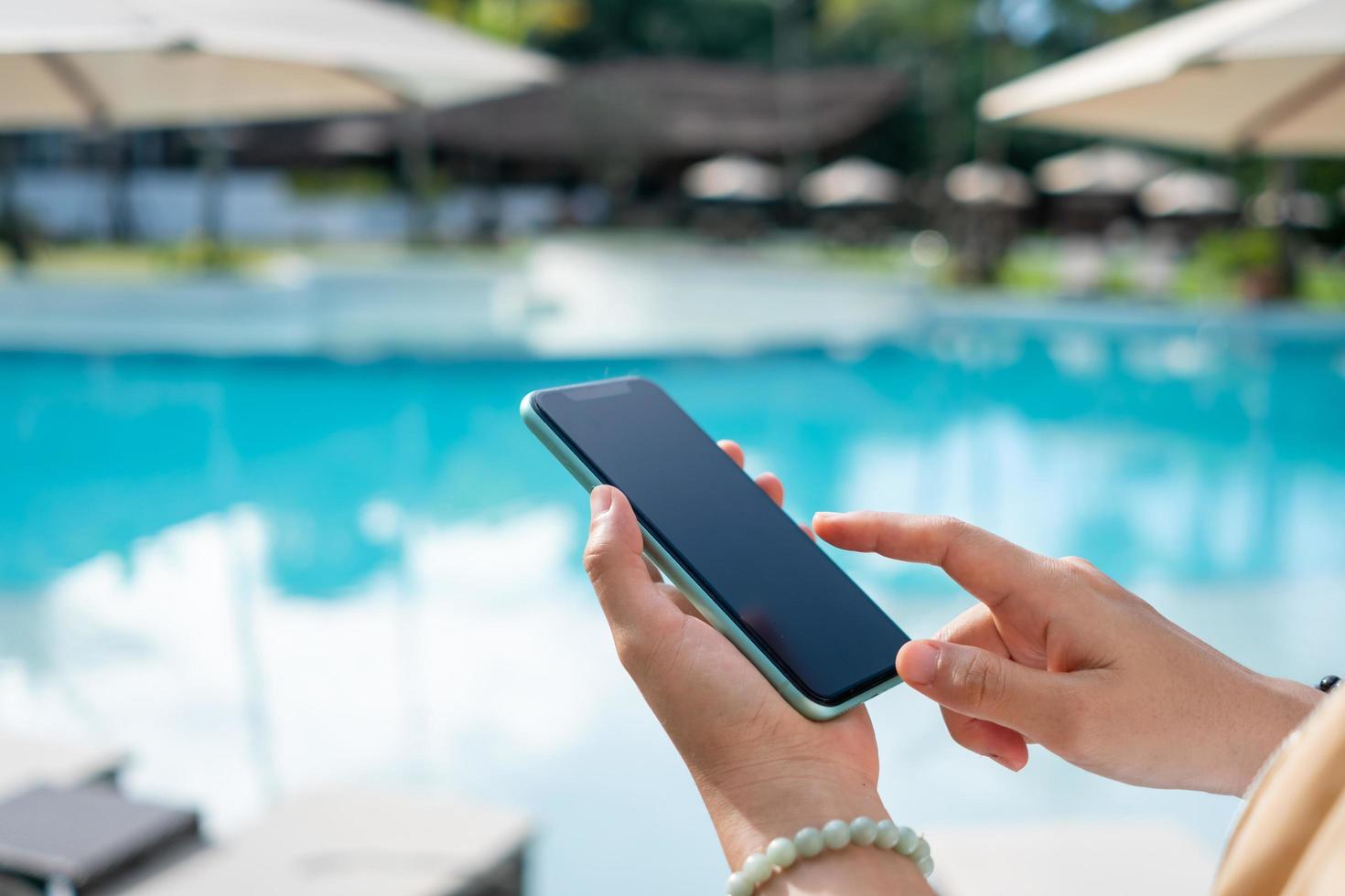 Woman hand using smartphone to do work business, social network, communication. photo