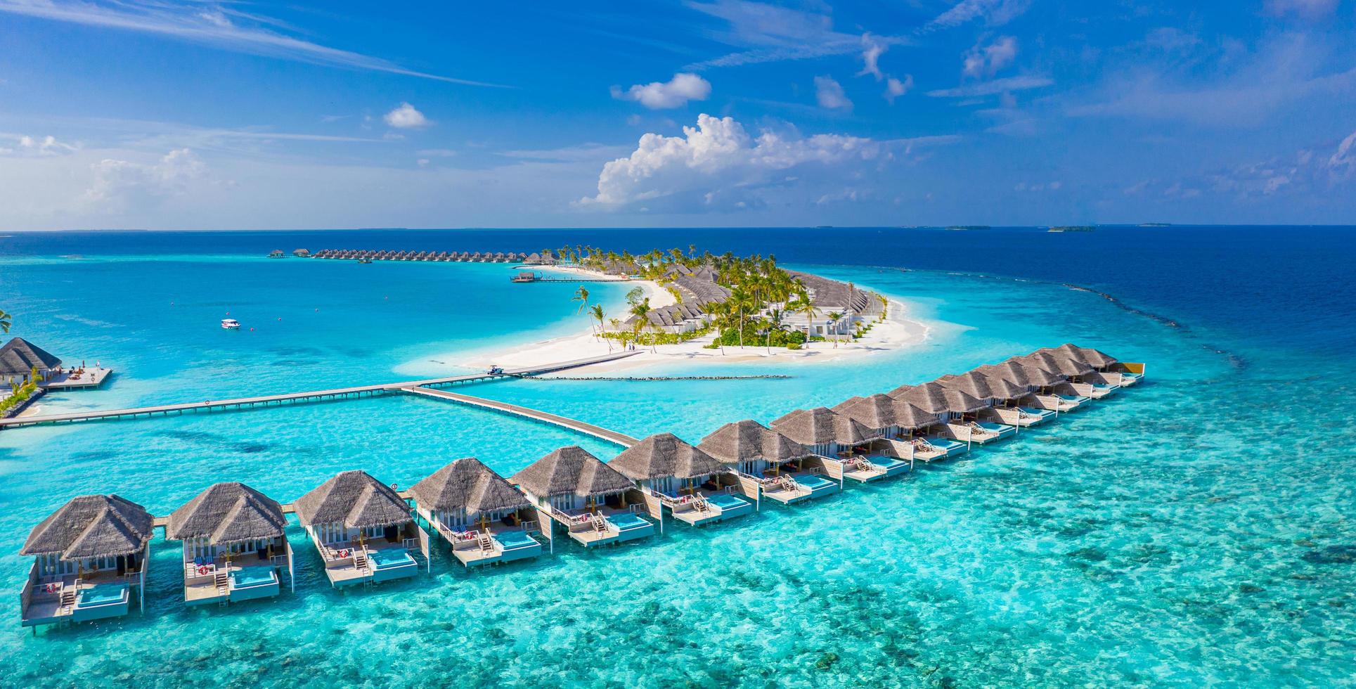 10.18.19 - atolón de male sur, vista aérea de maldivas isla de maldivas, muelle de madera de resort de villas de agua de lujo. impresionante playa de la laguna del océano del cielo. vacaciones de verano. panorama del paisaje aéreo del paraíso foto
