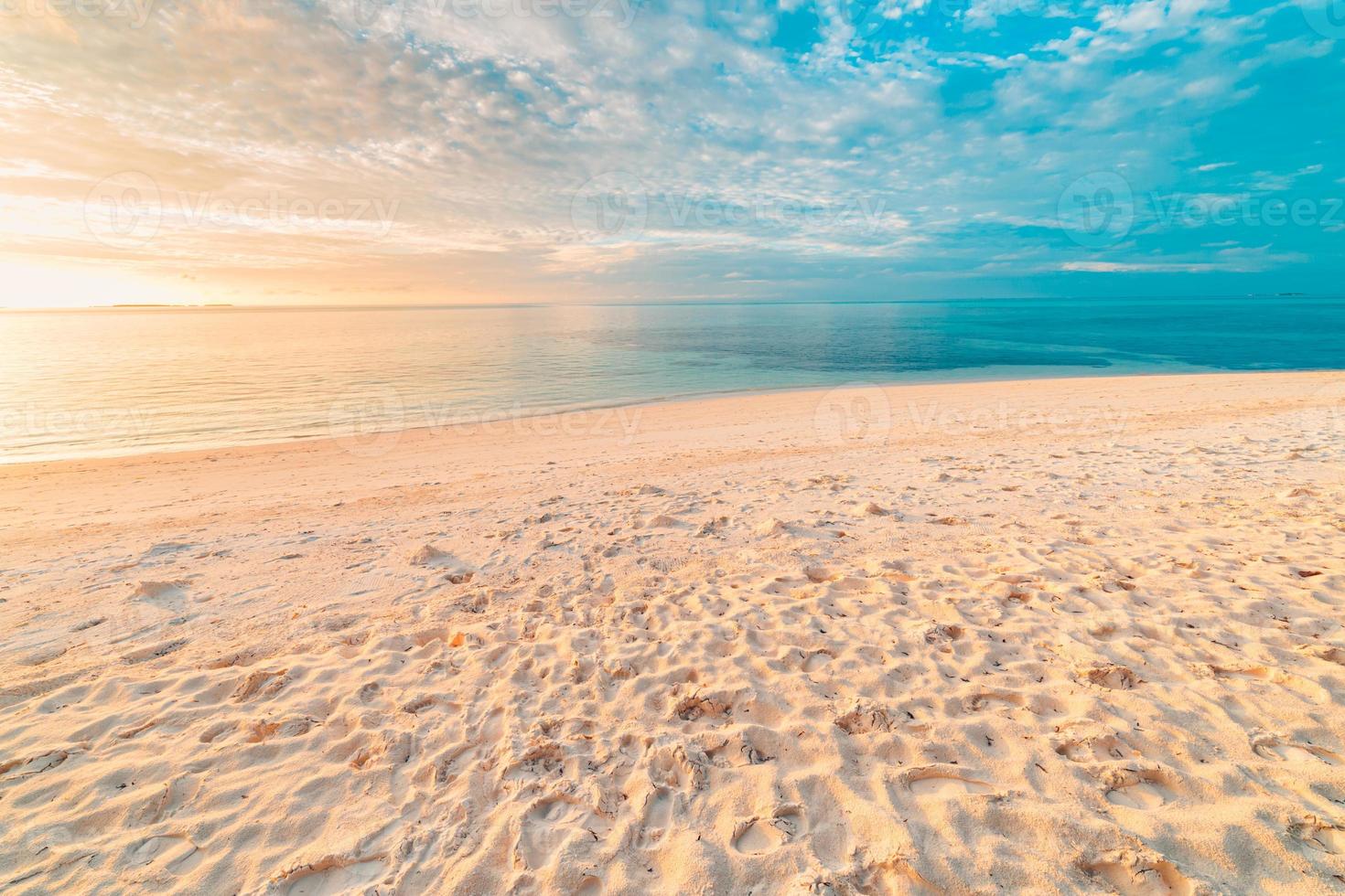 Closeup sea sand beach. Panoramic beach landscape. Inspire tropical beach seascape horizon. Orange and golden sunset sky calmness tranquil relaxing sunlight summer mood. Vacation travel holiday banner photo