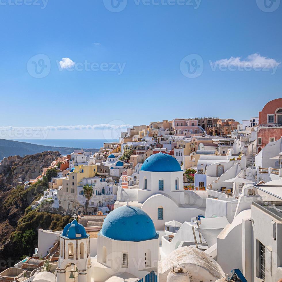 Amazing panoramic landscape, luxury travel vacation. Oia town on Santorini island, Greece. Traditional and famous houses and churches with blue domes over the Caldera, Aegean sea photo