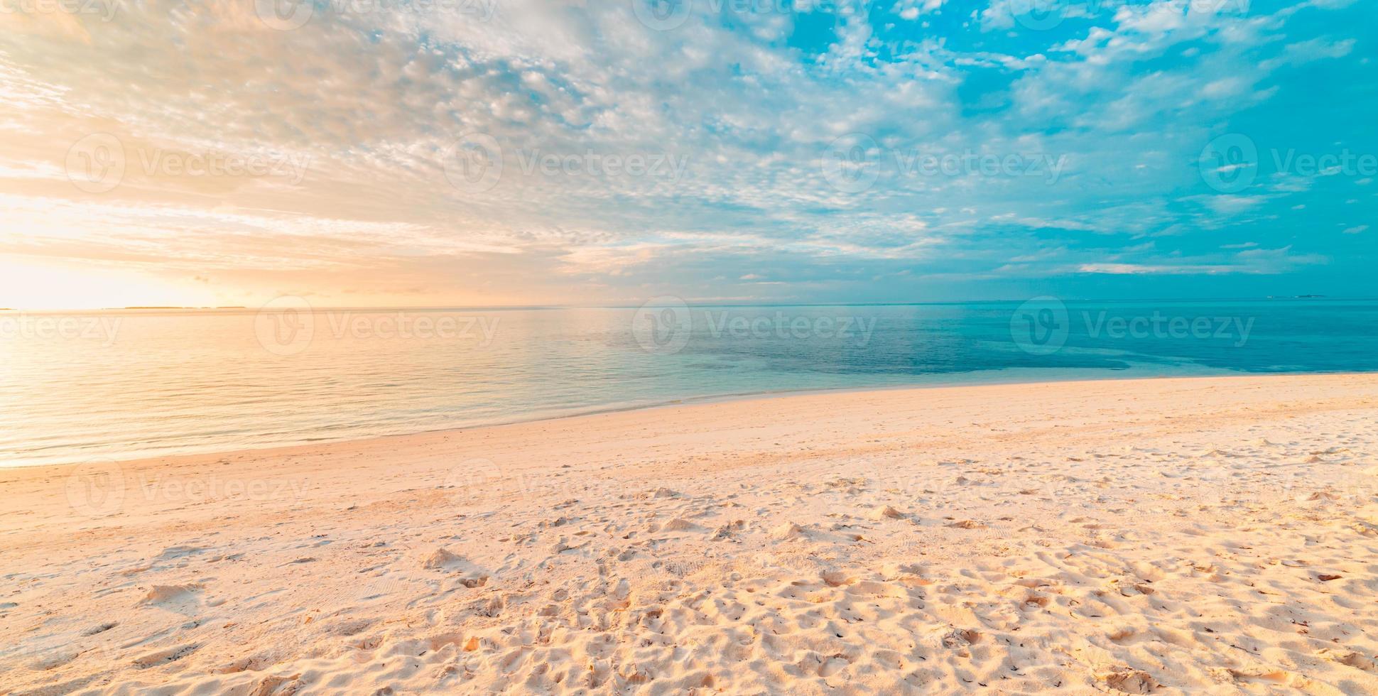 Closeup sea sand beach. Panoramic beach landscape. Inspire tropical beach seascape horizon. Orange and golden sunset sky calmness tranquil relaxing sunlight summer mood. Vacation travel holiday banner photo