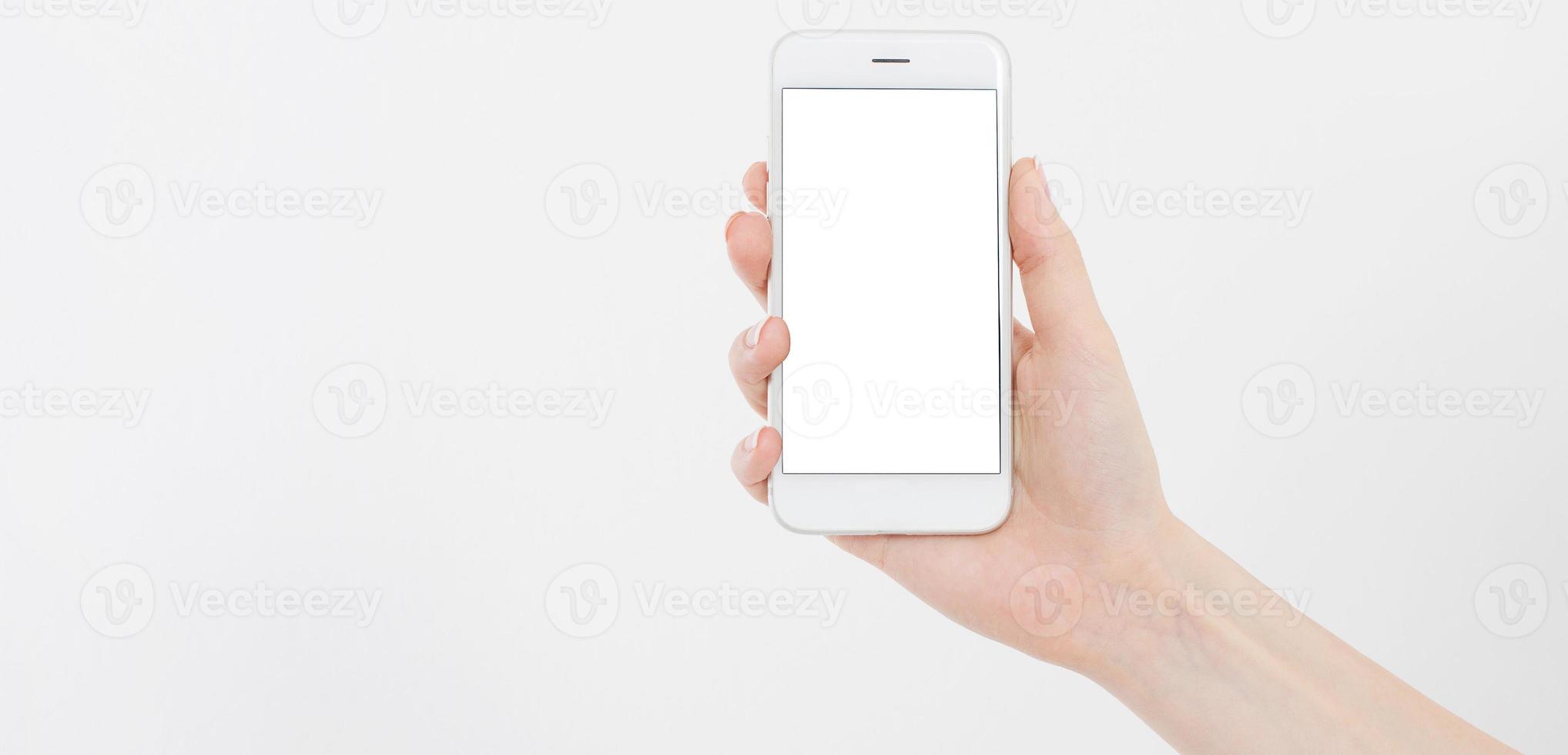 female hand hold mobile phone isolated on white, woman holding phone with empty display,blank screen,touching photo