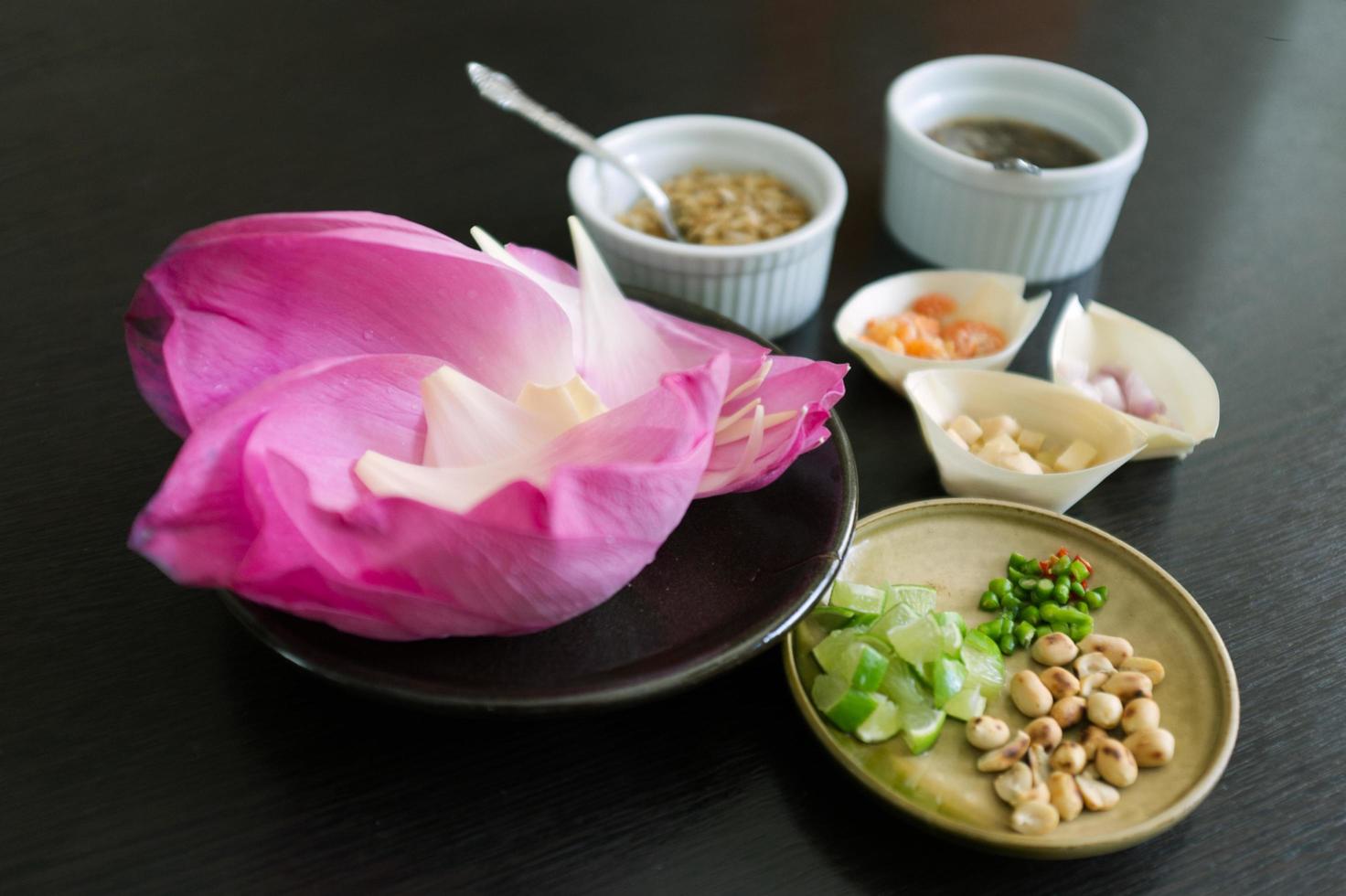 miang kham bua luang, bocadillos tailandeses tradicionales envolturas de pétalos de loto con salsa de azúcar y nueces, jengibre, camarones secos, hojuelas de coco foto