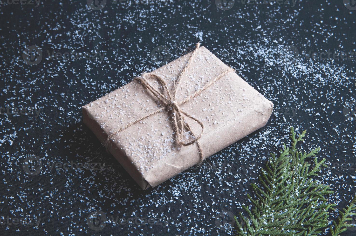 Gift box with snow on a dark background. photo