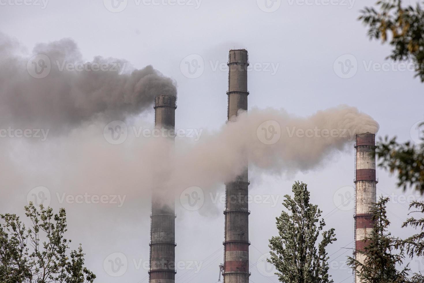 Smoke from the pipes of heat station photo