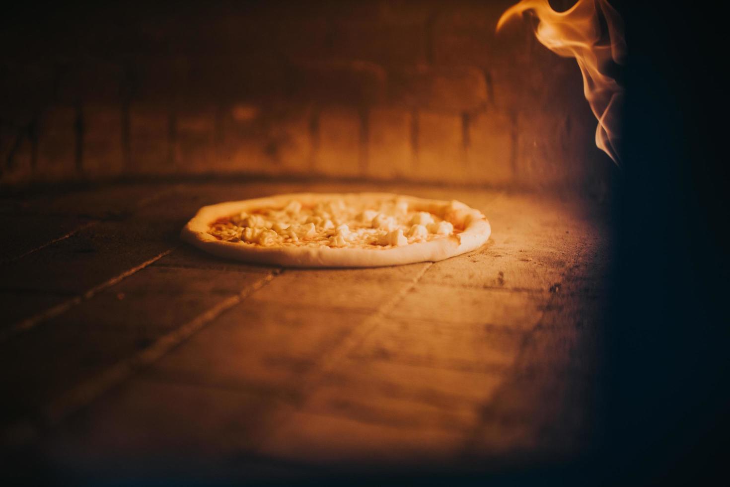 pizza baking in oven photo