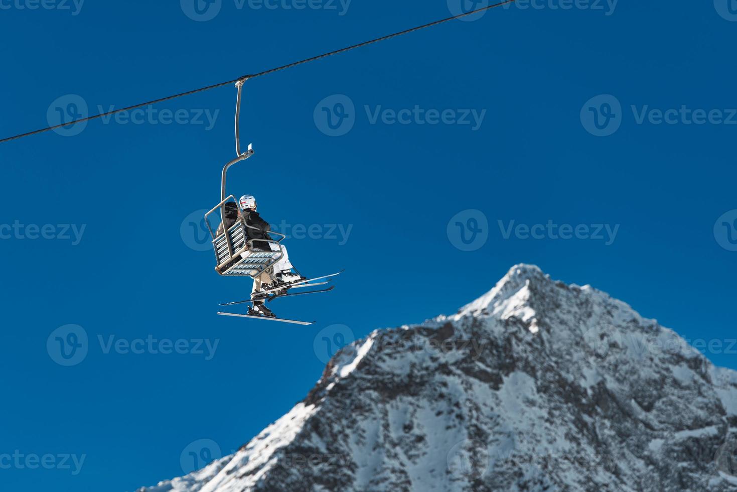 Skiers on the chairlift photo