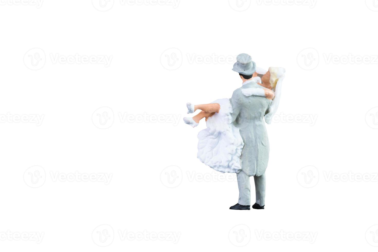 Close up of Miniature people wedding bride and groom couple isolated with clipping path on white background.Elegant Design with copy space for placement your text, mock up for love and wedding concept photo