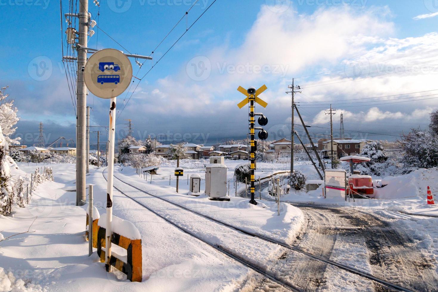 Railway track for local train with white snow fall in winter season,Japan photo