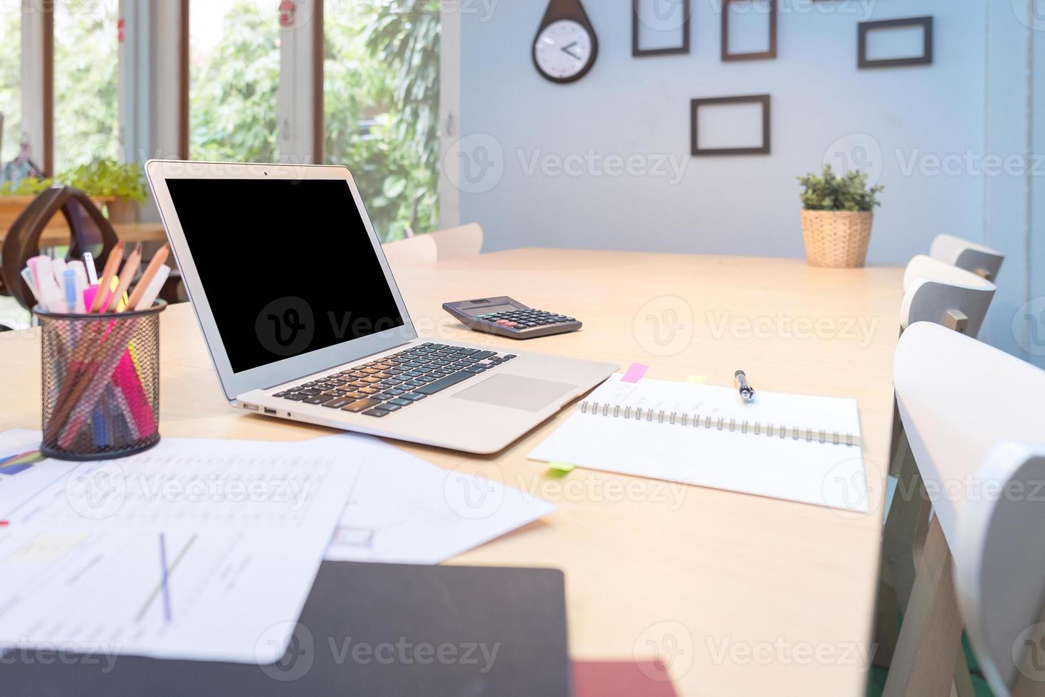 Smart computer and document put on wooden table in Co Working Space, new working office style for startup business owner and freelance. photo