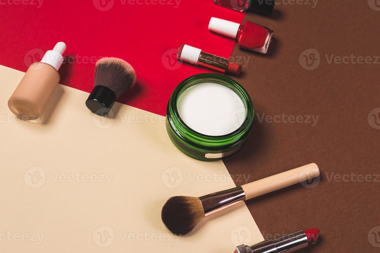 make up stuff on a brown red and cream color background photo