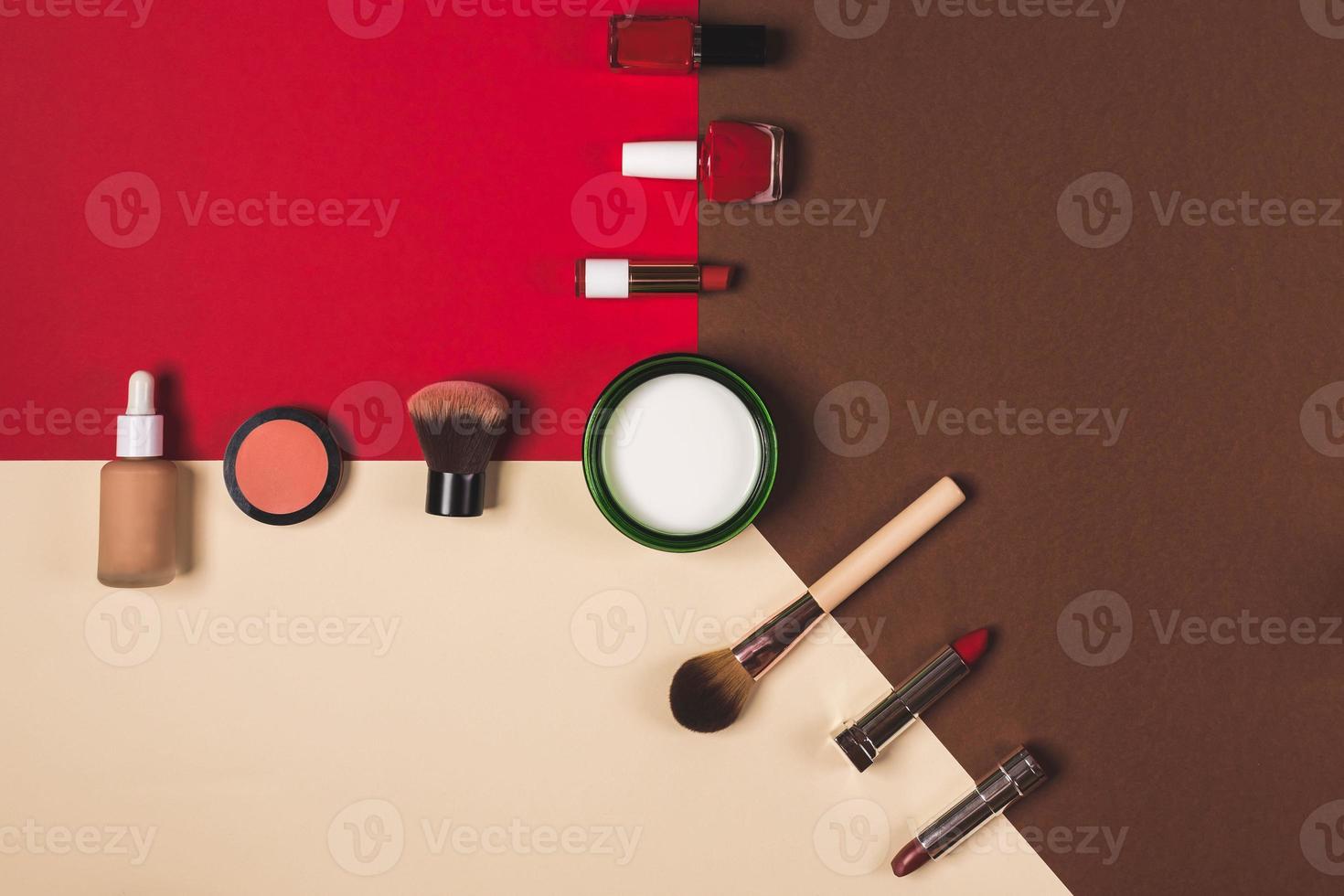 make up stuff on a brown red and cream color background photo