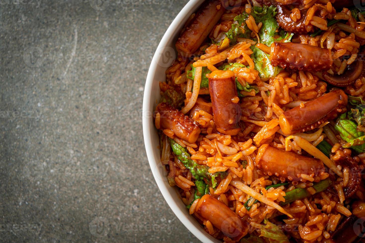 Stir-fried squid or octopus with Korean spicy sauce rice bowl photo