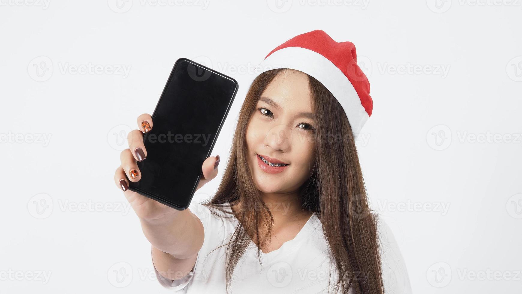 Asian woman with smartphone in hand which posing like selfie or video call photo