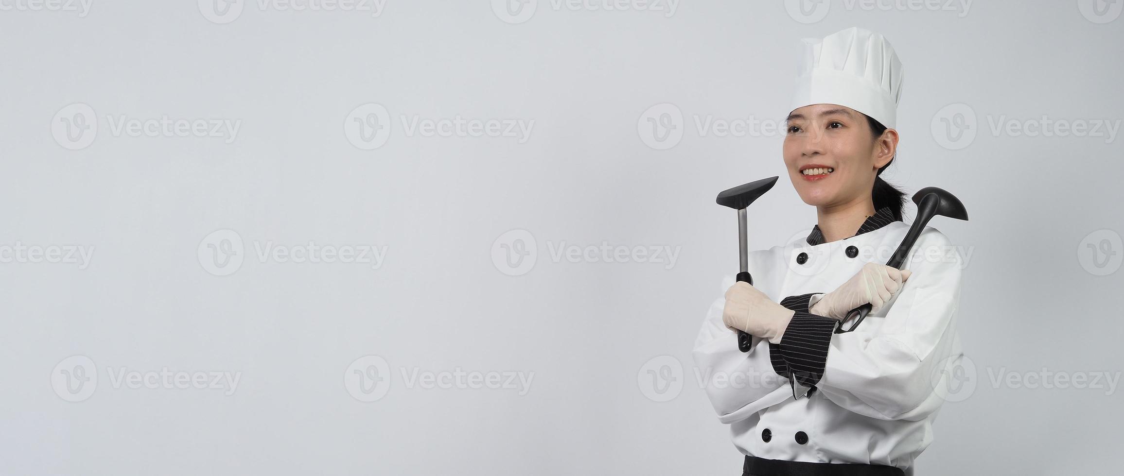 Asian woman chef holding smartphone or digital tablet and received order from online photo