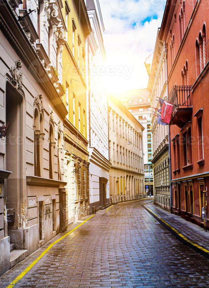 Classic paving stones street and architecture in Budapest, Hungary on sunset after a short spring rainy day. photo