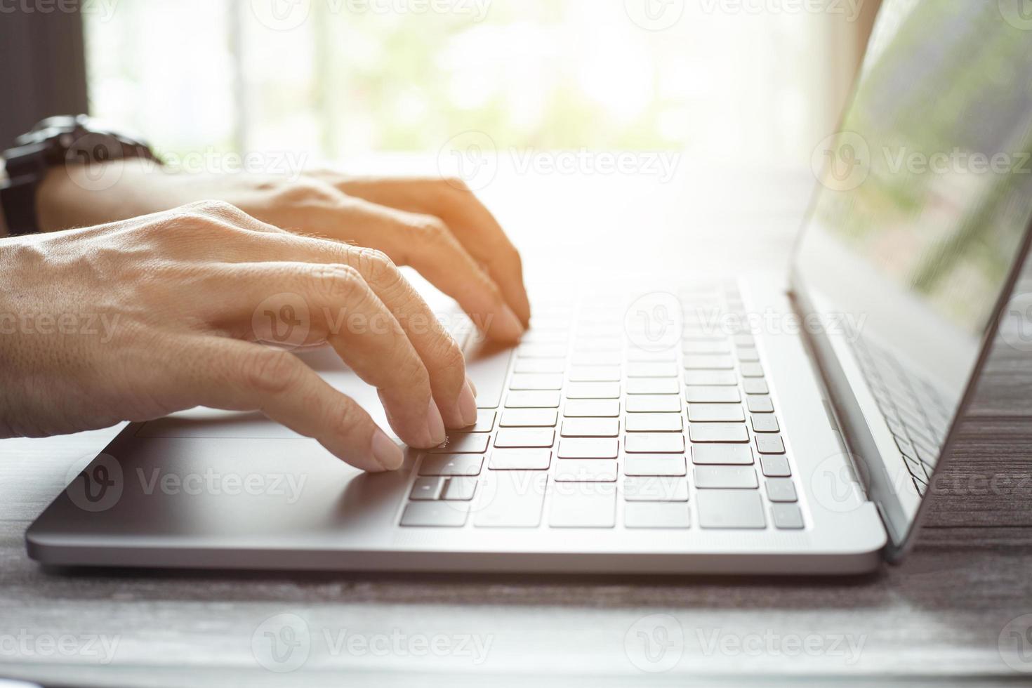 Man typing keyboard on laptop or computer photo
