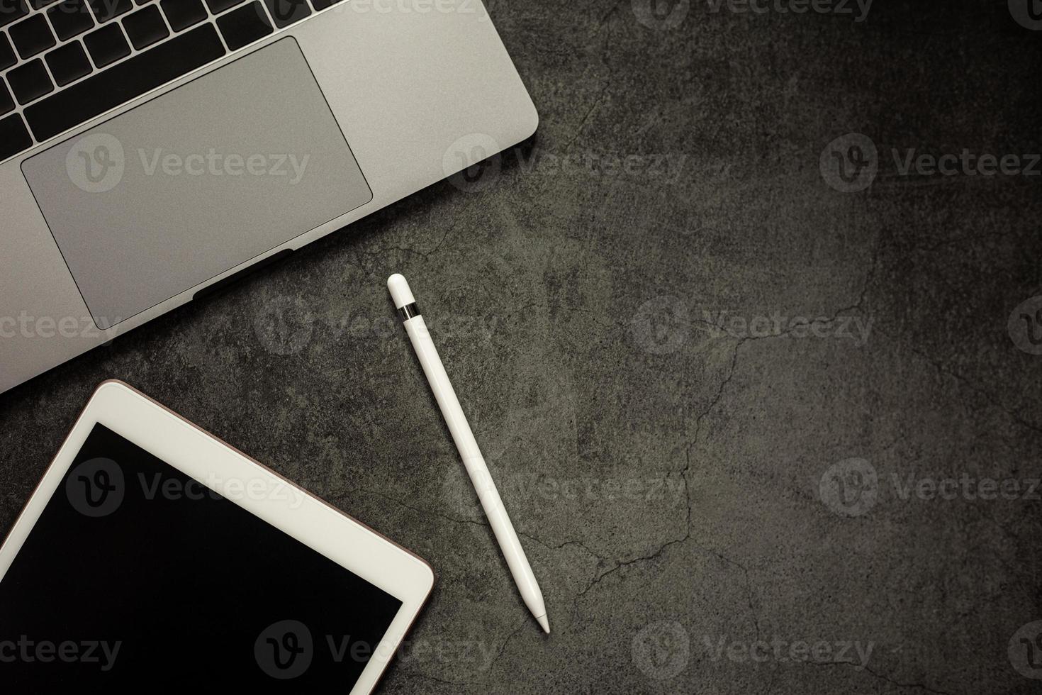 Education e-learning concept, Blank screen tablet with notebook on black table background, photo