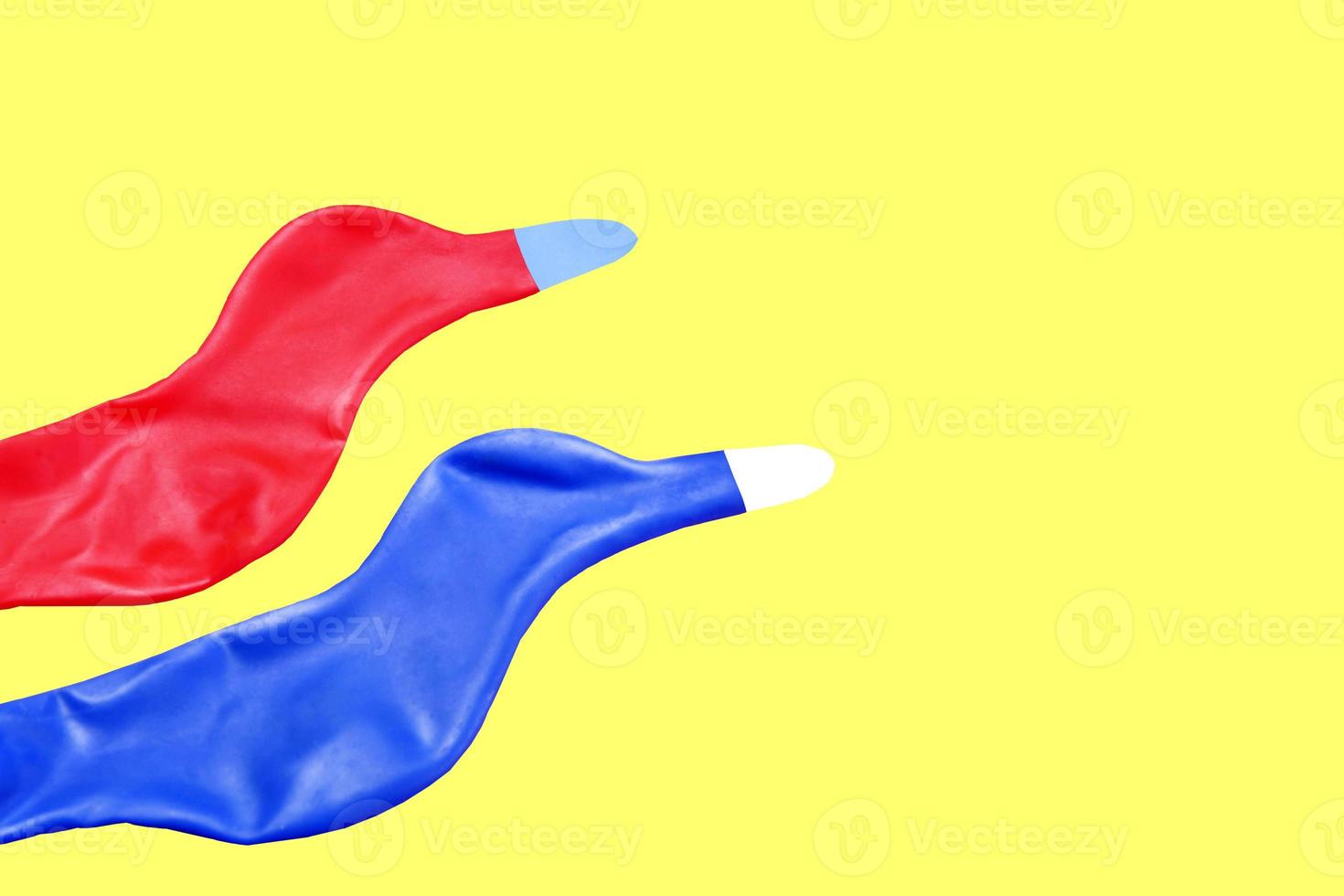 A pair of birds, two colored rubber balloons flying high without a care in a sky full of freedom and choices. photo