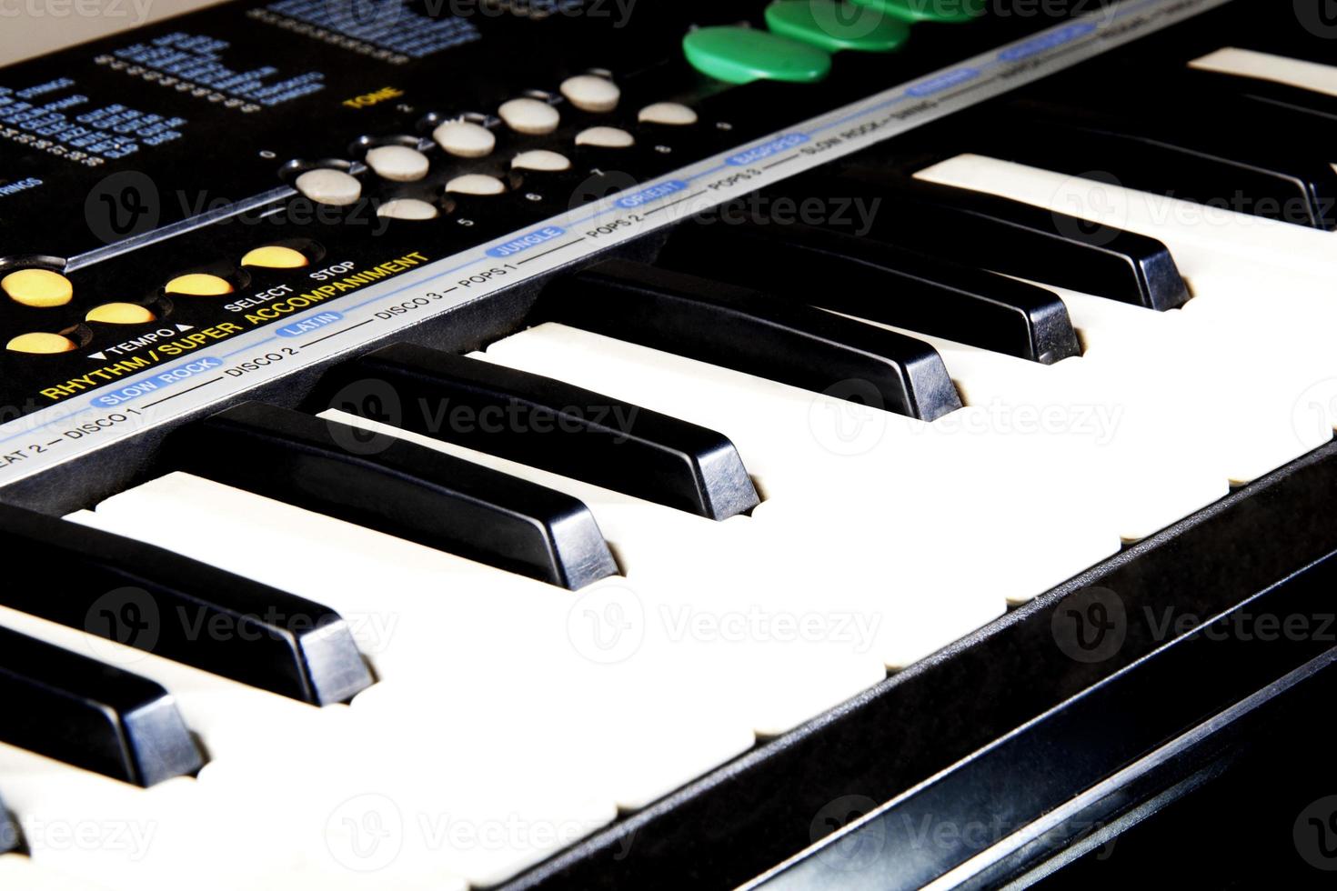 An electronic piano synthesizer showing its black and white keys on the keyboard. photo