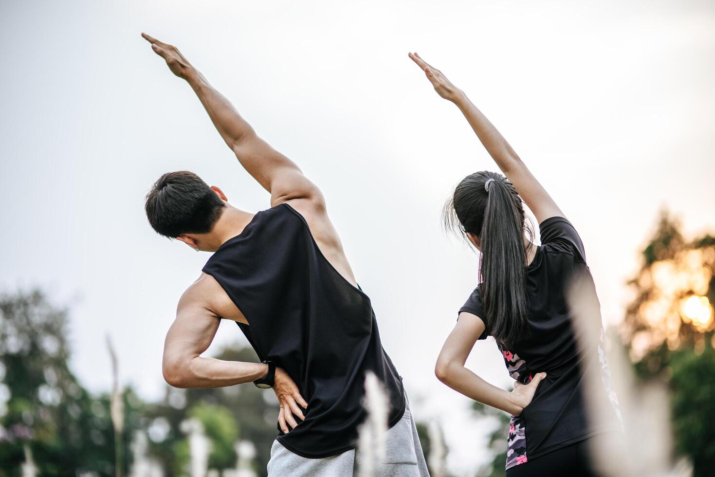 Men and women warm up before and after exercising. photo