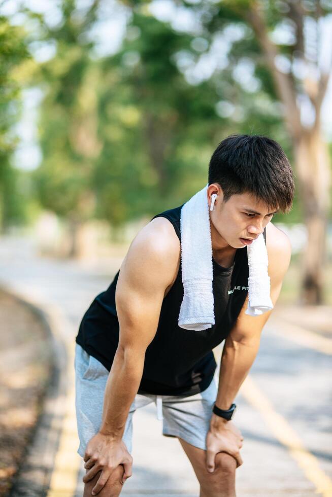 Men stand and bow and rest after exercising on the roadside. photo